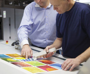 printers checking color balance on press proof